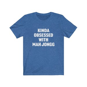 May include: A blue t-shirt with white text that reads "Kinda obsessed with Mah Jongg".