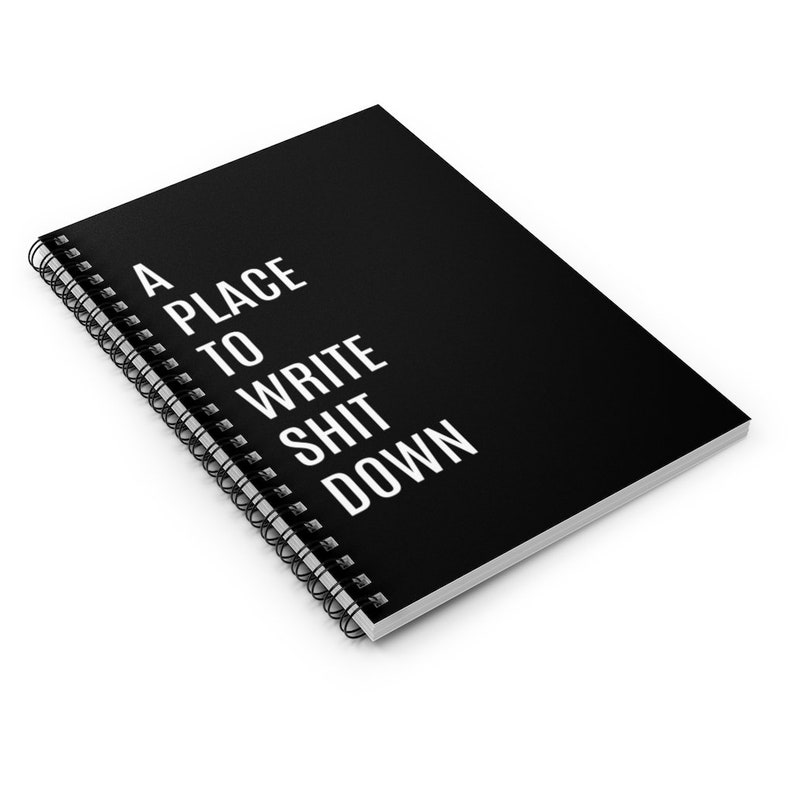 May include: A black spiral bound notebook with the text "A PLACE TO WRITE SHIT DOWN" in white.