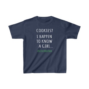 May include: A navy blue t-shirt with white text that reads "COOKIES? I HAPPEN TO KNOW A GIRL... #SCOUTBROTHER".