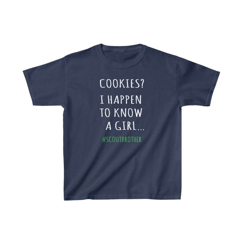 May include: A navy blue t-shirt with white text that reads "COOKIES? I HAPPEN TO KNOW A GIRL... #SCOUTBROTHER".