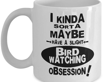 May include: White ceramic coffee mug with black text that reads "I kinda sorta maybe have a slight bird watching obsession!"