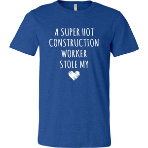 May include: A royal blue t-shirt with white text that reads "A super hot construction worker stole my heart".