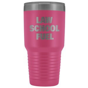 May include: A pink stainless steel tumbler with a silver lid. The tumbler has the text "LAW SCHOOL FUEL" engraved on the front.
