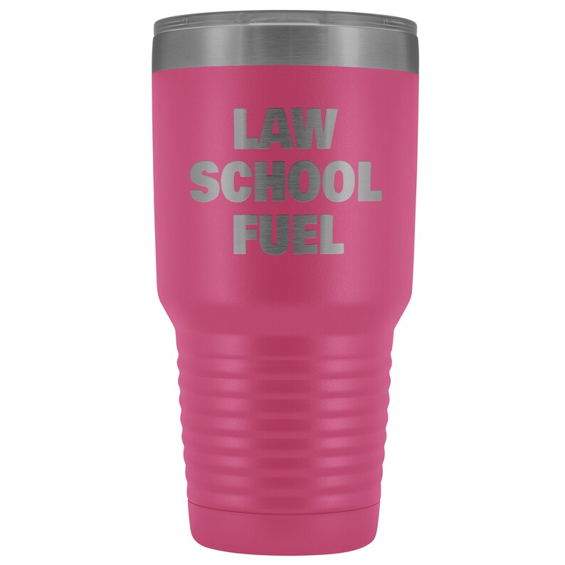 May include: A pink stainless steel tumbler with a silver lid. The tumbler has the text "LAW SCHOOL FUEL" engraved on the front.