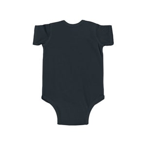 May include: A plain black baby onesie with short sleeves.