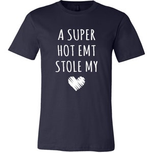 May include: A navy blue t-shirt with white text that reads "A super hot EMT stole my heart".