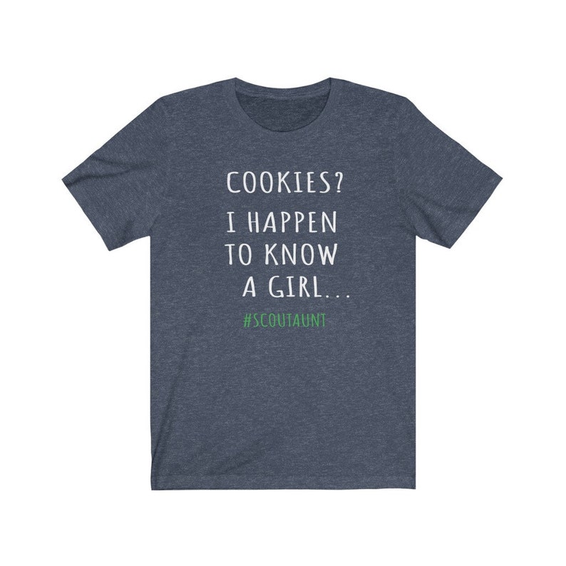 May include: A dark blue t-shirt with white text that reads "COOKIES? I HAPPEN TO KNOW A GIRL... #SCOUTAUNT".