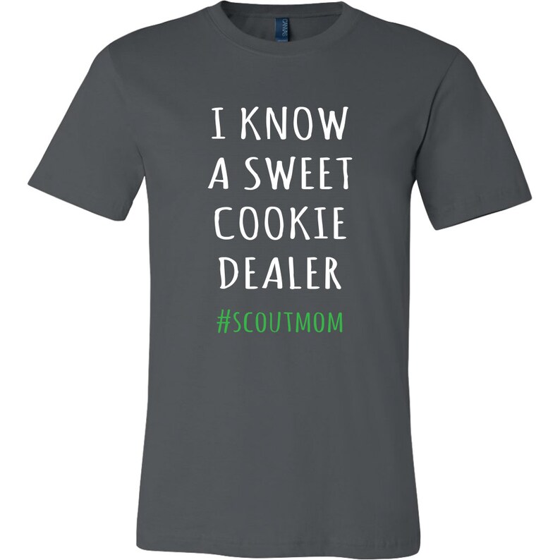 May include: A dark gray t-shirt with white text that reads "I know a sweet cookie dealer #scoutmom".