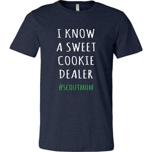 May include: Navy blue t-shirt with white text that reads "I know a sweet cookie dealer #scoutmom".