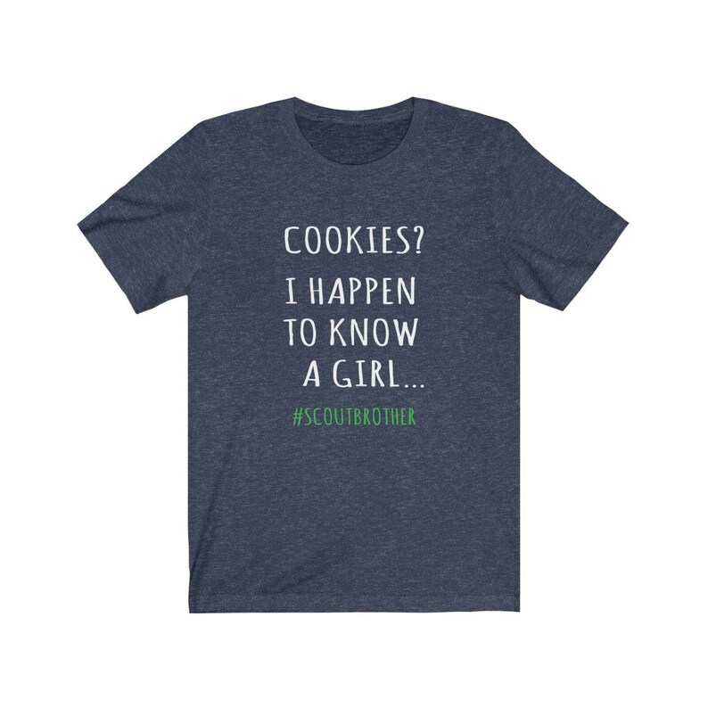 May include: A navy blue t-shirt with white text that reads "COOKIES? I HAPPEN TO KNOW A GIRL... #SCOUTBROTHER".