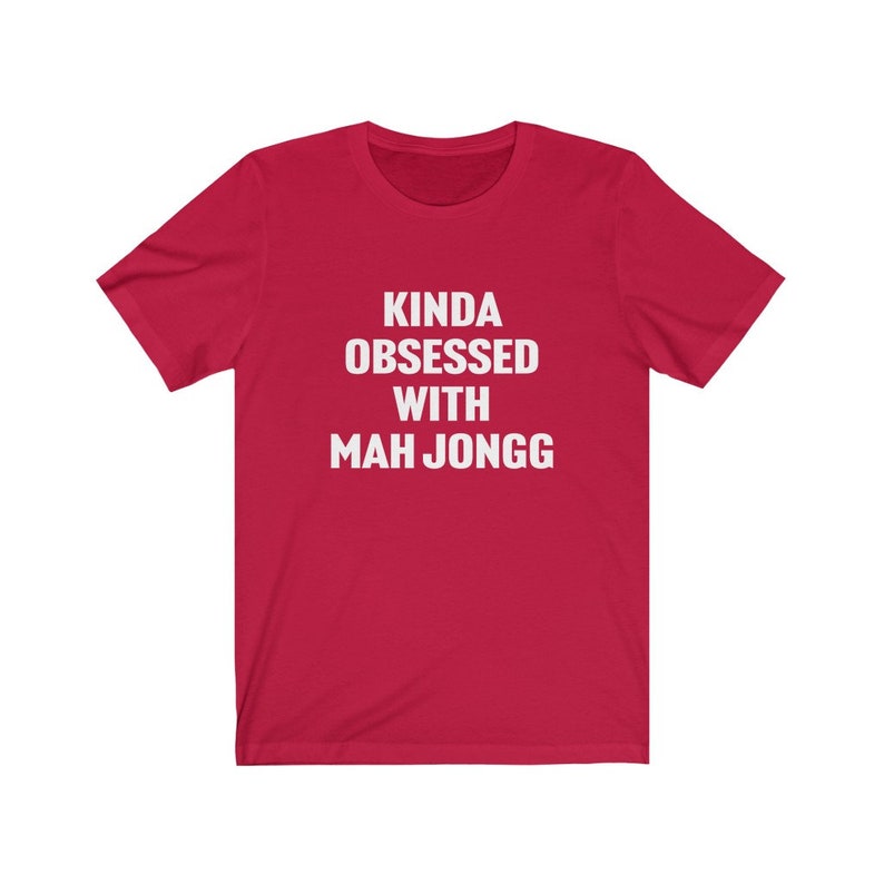 May include: Red short-sleeved t-shirt with white text that reads "Kinda obsessed with Mah Jongg".