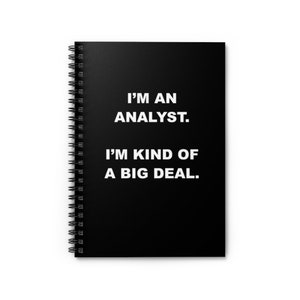 May include: Black spiral bound notebook with white text that reads "I'm an analyst. I'm kind of a big deal."