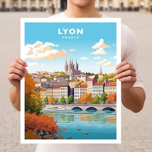 May include: A colourful illustration of the city of Lyon, France. The illustration features a cityscape with buildings, a river, and a bridge. The text "LYON FRANCE" is at the top of the illustration.