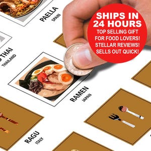 May include: A food-themed poster featuring illustrations of various dishes from around the world, including ramen from Japan, paella from Spain, and Thai food. A hand is holding a coin over the poster. The poster has a red circle with text.
