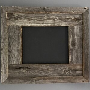 May include: A rustic wooden picture frame with a dark gray background. The frame is made of reclaimed wood with a natural wood grain and knots. The frame has a double border with a raised edge.