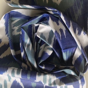 May include: Blue and white ikat fabric with a swirling pattern. The fabric is soft and silky.