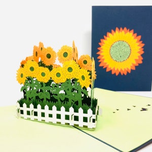 Tarjeta emergente hecha a mano con girasoles en valla blanca 3D