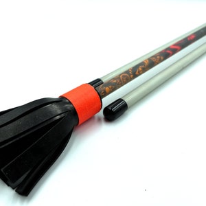 May include: A black and orange telescopic baton with a black foam tip. The baton is extended and the foam tip is visible.