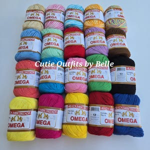 May include: A collection of twenty balls of Omega mercerized cotton yarn in various solid colors including yellow, pink, blue, green, red, brown, and black, each featuring a white paper label with the brand name Omega and product details.