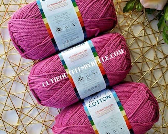 May include: Three balls of pink yarn with labels that read "24/7 Cotton" and "Lion Brand.com". The labels also include the text "3.5 oz / 100g" and "186 yds / 170 m".