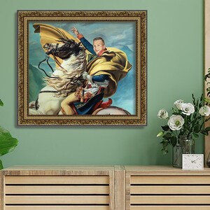 May include: A framed painting of a person riding a white horse. The person is wearing a yellow and blue outfit and a yellow cape. The background is a blue sky with white clouds.
