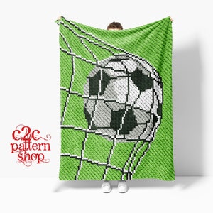 May include: A crochet blanket pattern featuring a soccer ball going into the net. The pattern is green with white and black details. The pattern is called "C2C pattern shop".