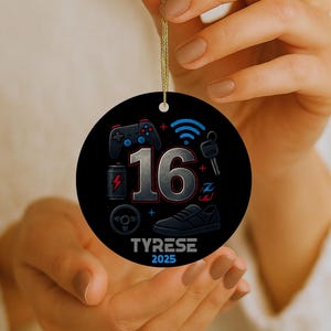 May include: A round black ornament featuring the number 16 in the center, surrounded by icons of a game controller, Wi-Fi symbol, battery, steering wheel, and sneaker. The text TYRESE and 2025 are printed at the bottom in white and blue.