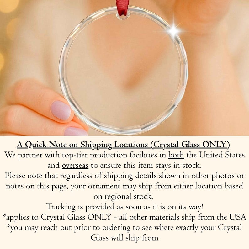 May include: A circular, clear glass ornament with a faceted edge and a small hole at the top for hanging. A thin, dark red ribbon is threaded through the top opening of the transparent, reflective glass disc, which catches light to create a bright flare.