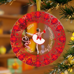 May include: A round glass Christmas ornament with a red and white ballerina in a white tutu and red shoes. The ornament has a red and white candy cane design with the words "Candy Cane Express" and "2024" on it. The name "Sami" is written on the ornament.