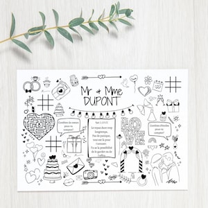 Op de afbeelding: Een zwart-witte doodle-illustratie van een huwelijksuitnodiging met de tekst "Mr & Mme DUPONT" en verschillende doodles met een huwelijksthema, waaronder harten, ringen, een taart, een camera en een doolhof.