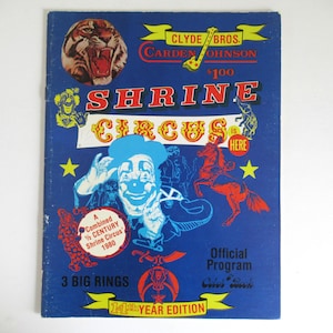 May include: A vintage Shrine Circus program cover in blue, featuring a tiger illustration, a clown, and a horse. Text includes "SHRINE CIRCUS", "3 BIG RINGS", and "14th YEAR EDITION".