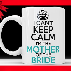 May include: White ceramic mug with a black crown and text that reads "I can't keep calm I'm the mother of the bride" in black and teal.