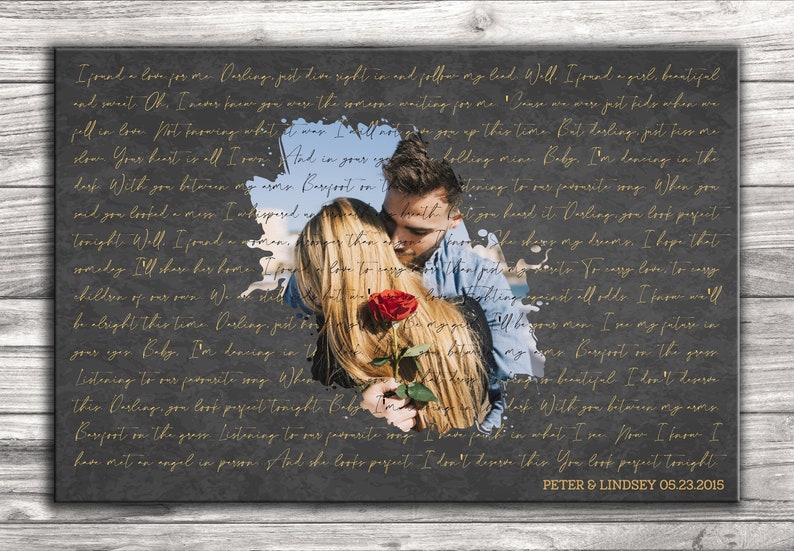 May include: A black and white canvas print with a gold inscription of a love letter. The inscription is partially obscured by a photo of a couple embracing with a red rose. The text at the bottom of the canvas reads "PETER & LINDSEY 05.23.2015".