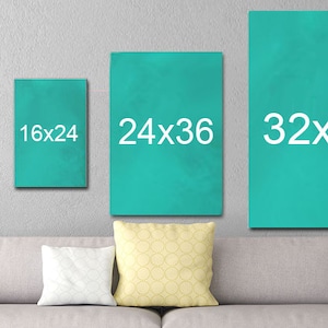 May include: Four teal canvas prints with white text showing different sizes: 12x18, 16x24, 24x36, and 32x48. The prints are hanging on a gray wall above a gray couch with white and yellow pillows.