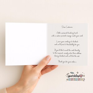 a hand holding a blank card with a personalized message written on it.