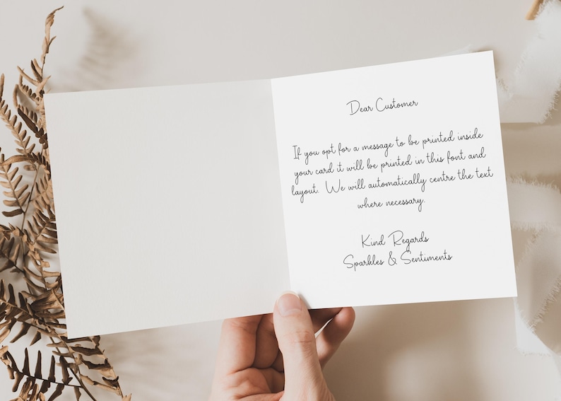 a person holding a piece of paper with a quote on it