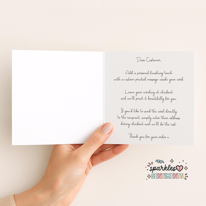 a hand holding a blank card with a personalized message written on it.