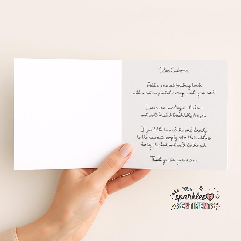 a hand holding a blank card with a personalized message written on it.