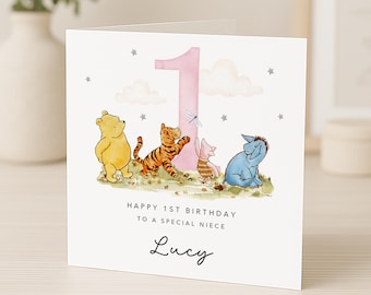 May include: A square greeting card featuring a large pink number one, watercolor illustrations of Winnie the Pooh, Tigger, Piglet, and Eeyore, and the text Happy 1st Birthday to a special niece and the name Lucy in black script font.