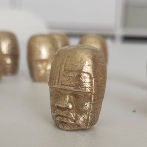 Olmec head natural brass pin.