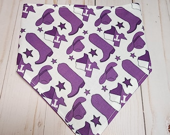 May include: Purple and white bandana with a repeating pattern of cowboy boots, hats, and stars. The bandana is triangular in shape and has a white background with purple accents.