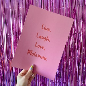 May include: Pink card with the text "Live, Laugh, Love, Moleman" written in a handwritten style.