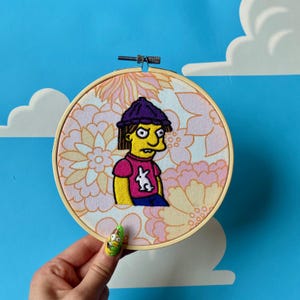 BABY JIMBO - Arte de pared con bastidor de bordado de Los Simpsons
