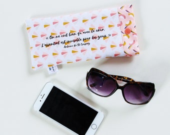 May include: A white and pink fabric eyeglass case with a quote in French by Antoine de Saint-Exupéry: "On ne voit bien qu'avec le cœur. L'essentiel est invisible pour les yeux." The case has a small pink button closure.