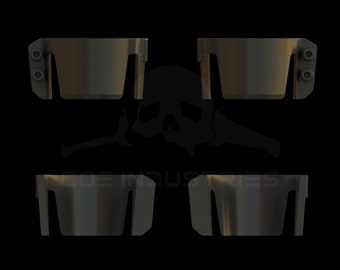May include: Four black plastic pieces with a rectangular shape and a small lip on each side. The pieces are arranged in a symmetrical pattern.