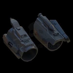 Könnte beinhalten: Zwei graue, 3D-gedruckte futuristische Armbefestigungen. Eine hat einen kleinen Raketenwerfer oben und die andere eine Reihe kleiner Löcher.