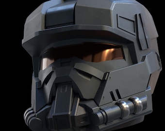 May include: A dark gray futuristic helmet with a visor and a detailed design. The helmet has a black and silver color scheme and a textured surface.