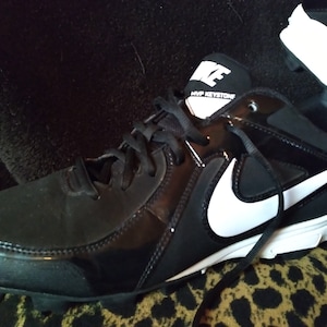 May include: Black and white baseball cleats with a white Nike swoosh and the text "MVP KEYSTONE" on the side.