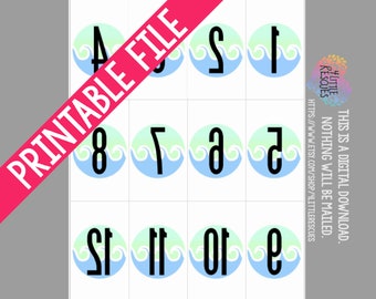 May include: Printable number stickers with a blue and green ocean wave design. The numbers 1 through 12 are displayed in black text on a white background.