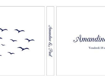 May include: A white rectangular card featuring a flock of dark blue birds in flight on the left side. The centre spine and right panel display the text Amandine & Paul in a dark blue script font, with the date Vendredi 18 septembre 2026 below.
